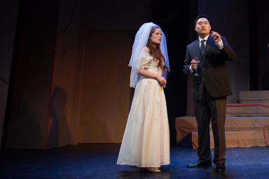 Eurydice in her wedding gown speaks with a strange man